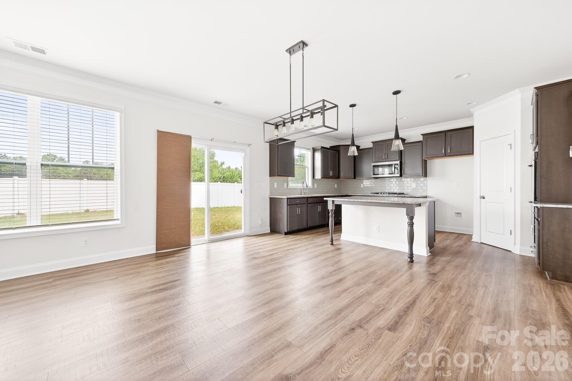5972 Redwood Pine Road Concord, NC 28027 - Photo 13 of 37 a view of a kitchen with a sink dishwasher cabinets and wooden floor