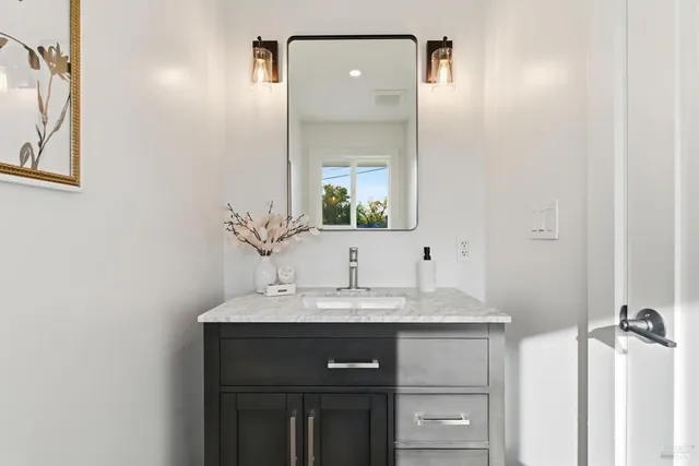 a bathroom with a sink and a mirror
