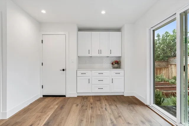 a view of a closet with wooden floor