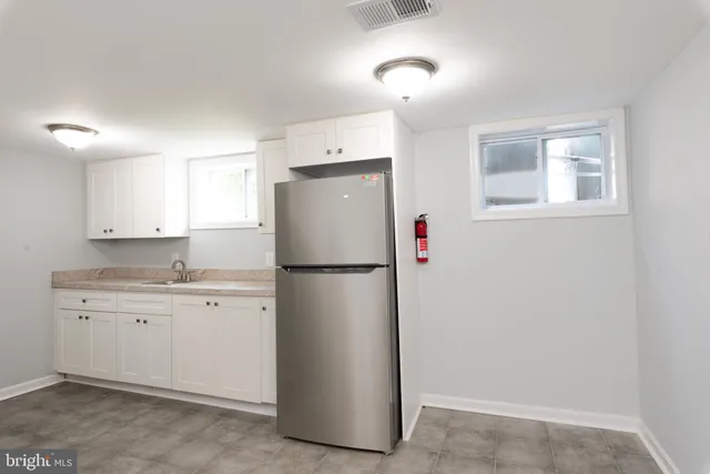 a white refrigerator freezer sitting in a kitchen