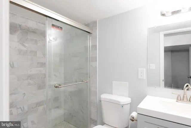 a bathroom with a toilet a sink and shower