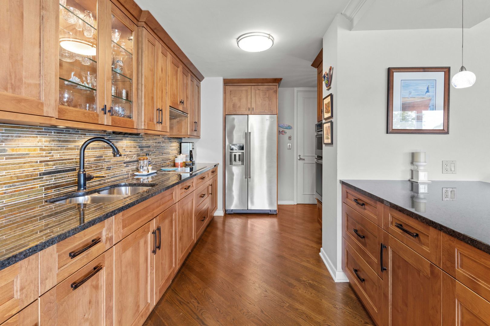 1630 Sheridan Road, Unit 4M Wilmette, IL 60091 - Photo 12 of 39 a large kitchen with stainless steel appliances a sink and cabinets
