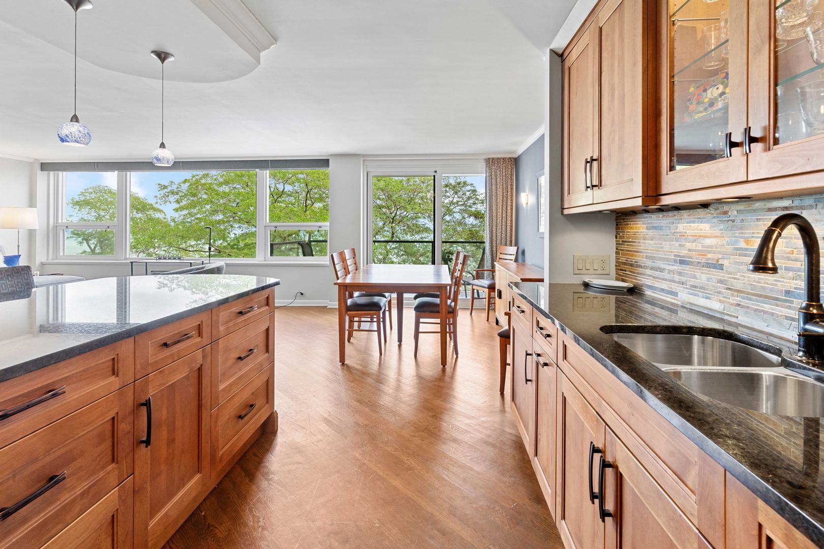 1630 Sheridan Road, Unit 4M Wilmette, IL 60091 - Photo 13 of 39 a kitchen with stainless steel appliances granite countertop a stove a sink and white cabinets with wooden floor