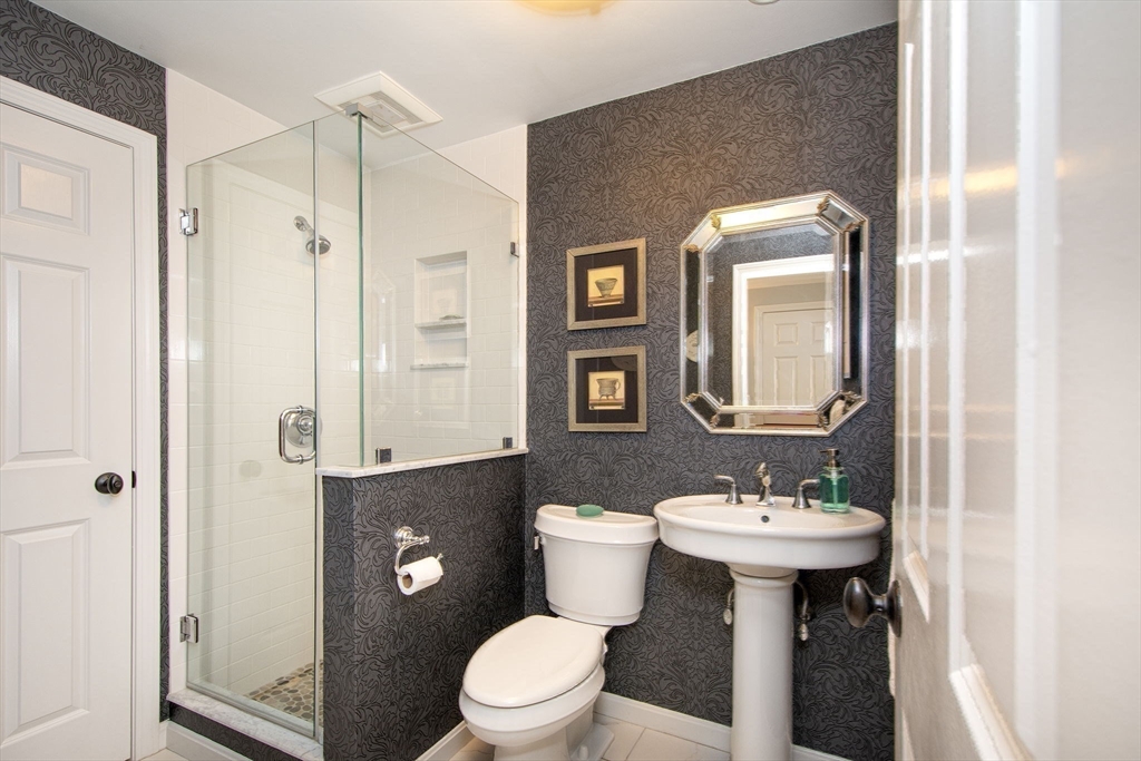 16 Ladds Way, Unit 16 Scituate, MA 02066 - Photo 17 of 40 a bathroom with a sink toilet and shower