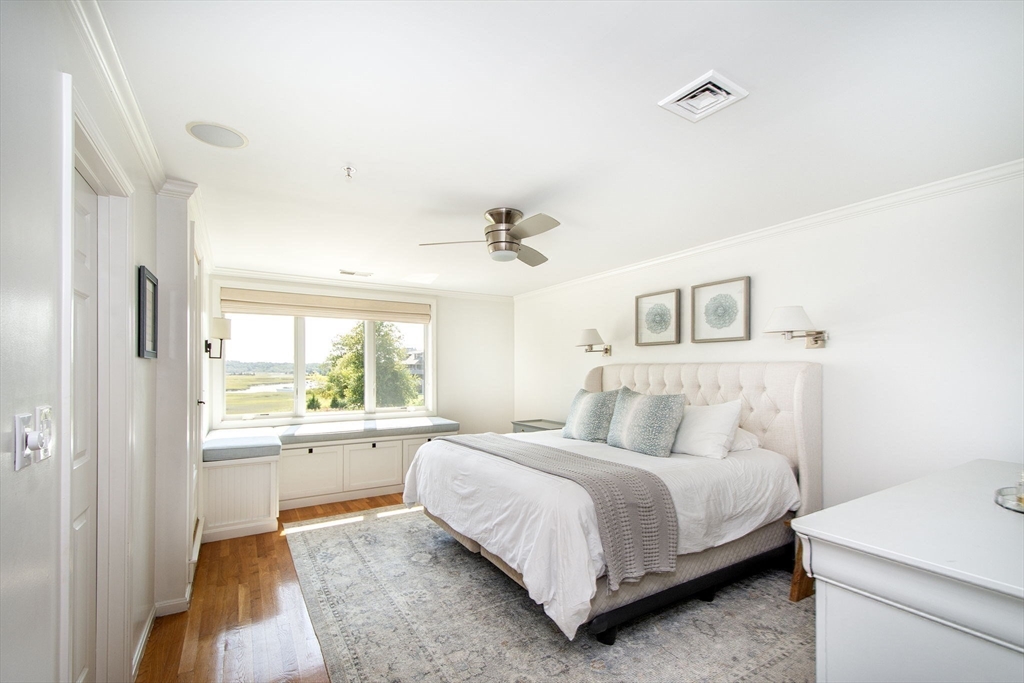 16 Ladds Way, Unit 16 Scituate, MA 02066 - Photo 19 of 40 a bedroom with a large bed and a chandelier
