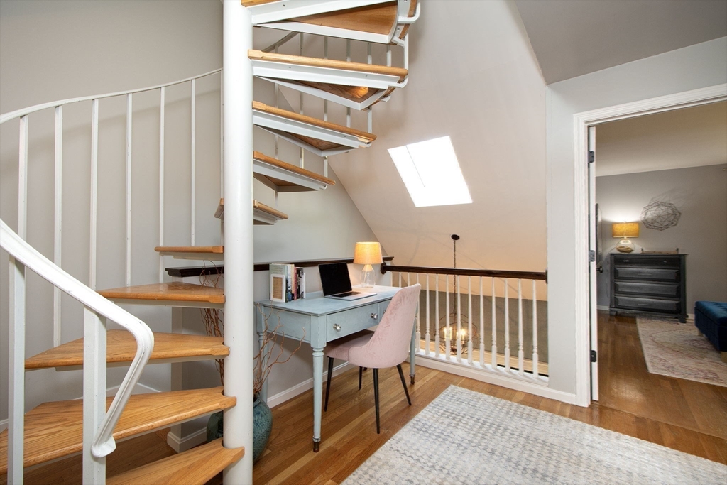16 Ladds Way, Unit 16 Scituate, MA 02066 - Photo 25 of 40 a view of a hallway with wooden floor and staircase