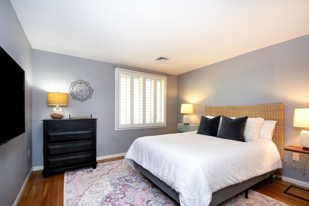 16 Ladds Way, Unit 16 Scituate, MA 02066 - Photo 26 of 40 a bedroom with a bed and lamps