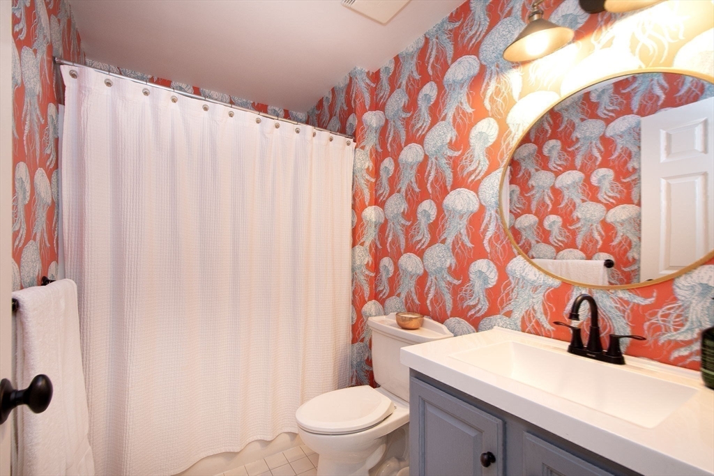 16 Ladds Way, Unit 16 Scituate, MA 02066 - Photo 27 of 40 a bathroom with a sink toilet and shower curtain