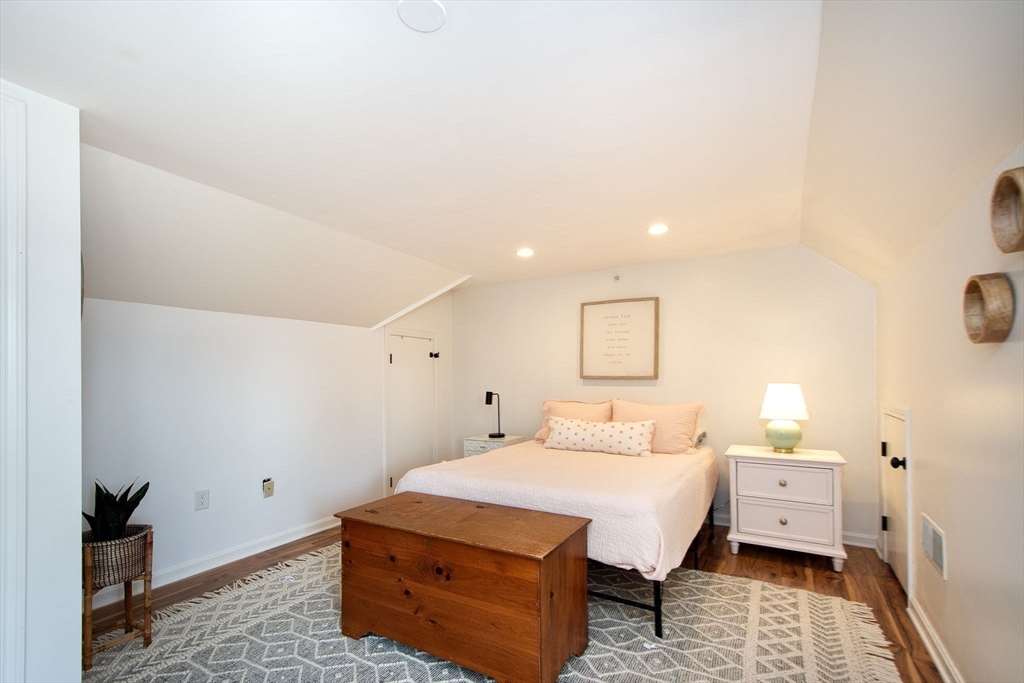 16 Ladds Way, Unit 16 Scituate, MA 02066 - Photo 28 of 40 a bedroom with a bed and wooden floor