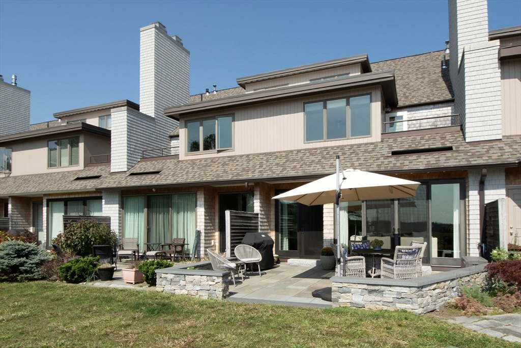 16 Ladds Way, Unit 16 Scituate, MA 02066 - Photo 32 of 40 a view of a house with backyard porch and sitting area