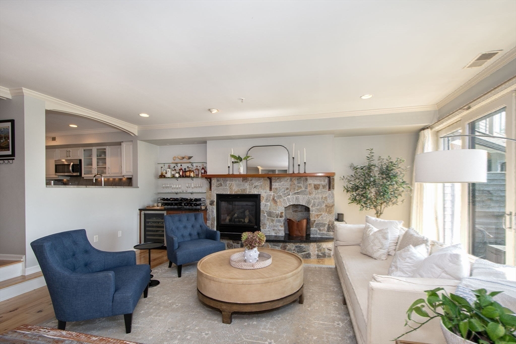 16 Ladds Way, Unit 16 Scituate, MA 02066 - Photo 10 of 40 a living room with furniture a fireplace and a large window