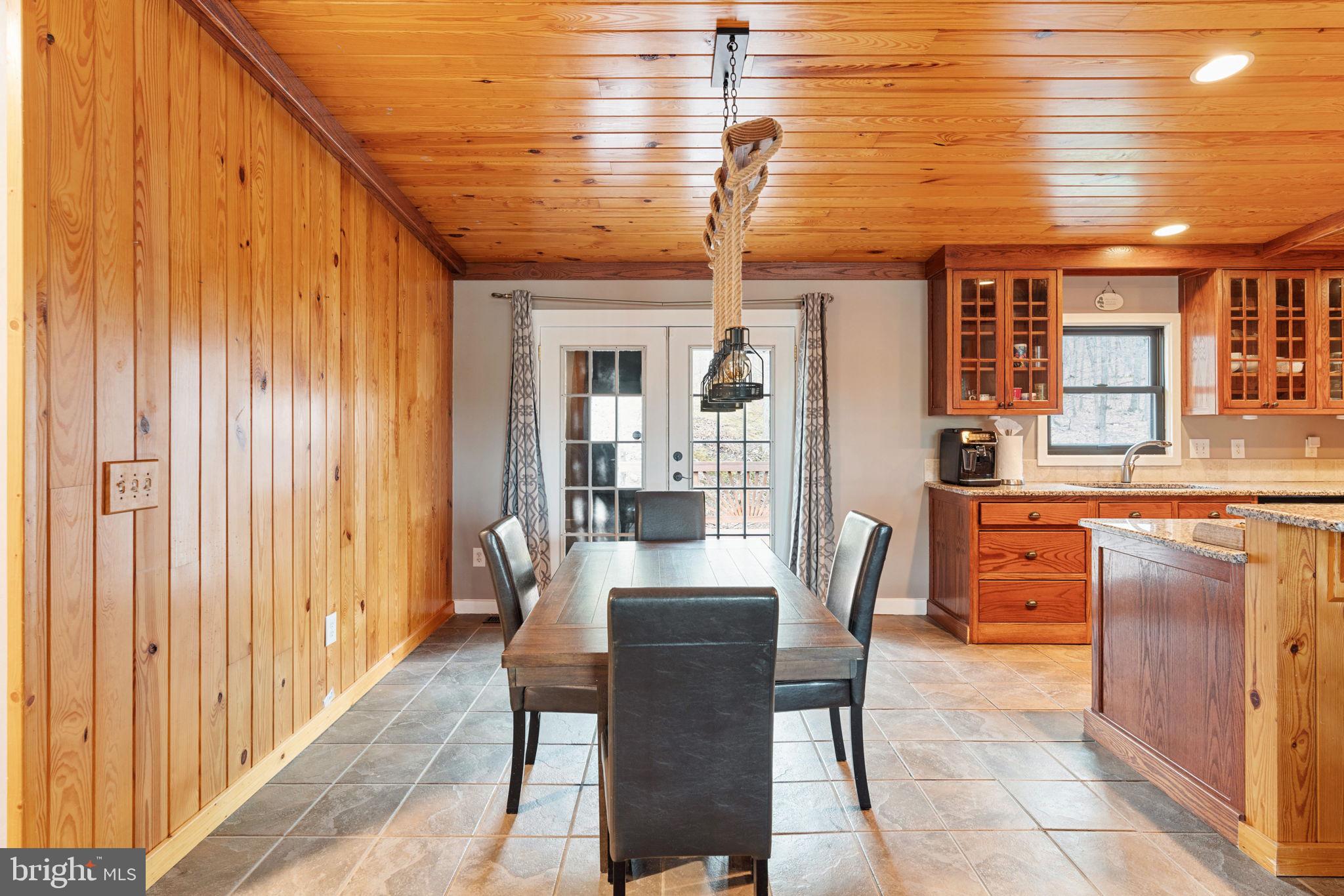 4098 Mountain Road Haymarket, VA 20169 - Photo 13 of 49 a dining room with stainless steel appliances kitchen island granite countertop a table chairs and a refrigerator