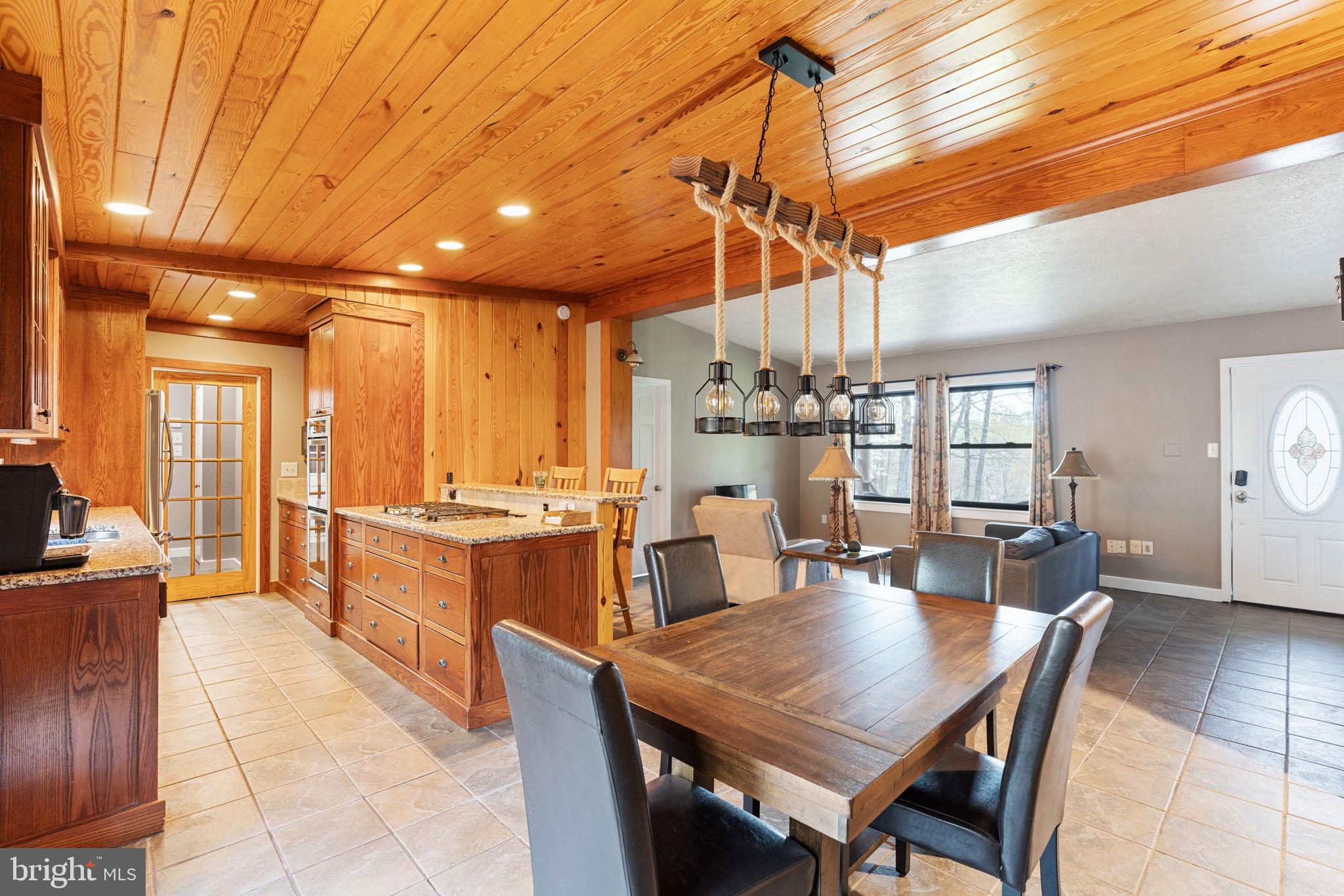 4098 Mountain Road Haymarket, VA 20169 - Photo 14 of 49 a view of a dining room and livingroom with furniture wooden floor a chandelier