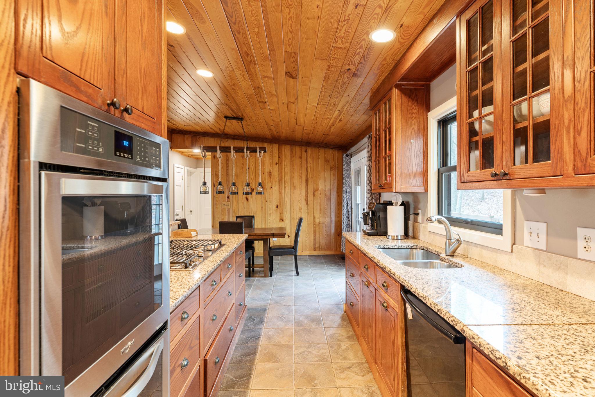 4098 Mountain Road Haymarket, VA 20169 - Photo 18 of 49 a kitchen with stainless steel appliances granite countertop sink stove and cabinets
