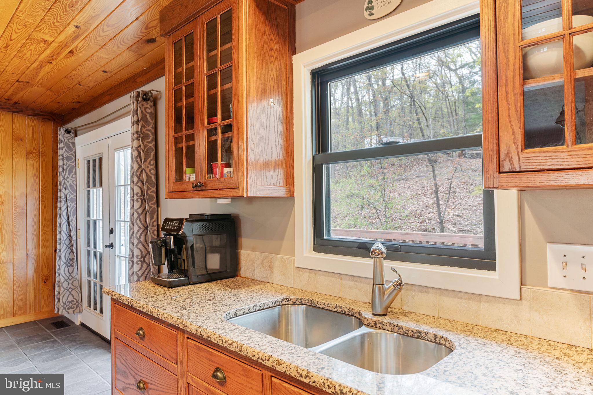 4098 Mountain Road Haymarket, VA 20169 - Photo 19 of 49 a kitchen with granite countertop a sink and a window