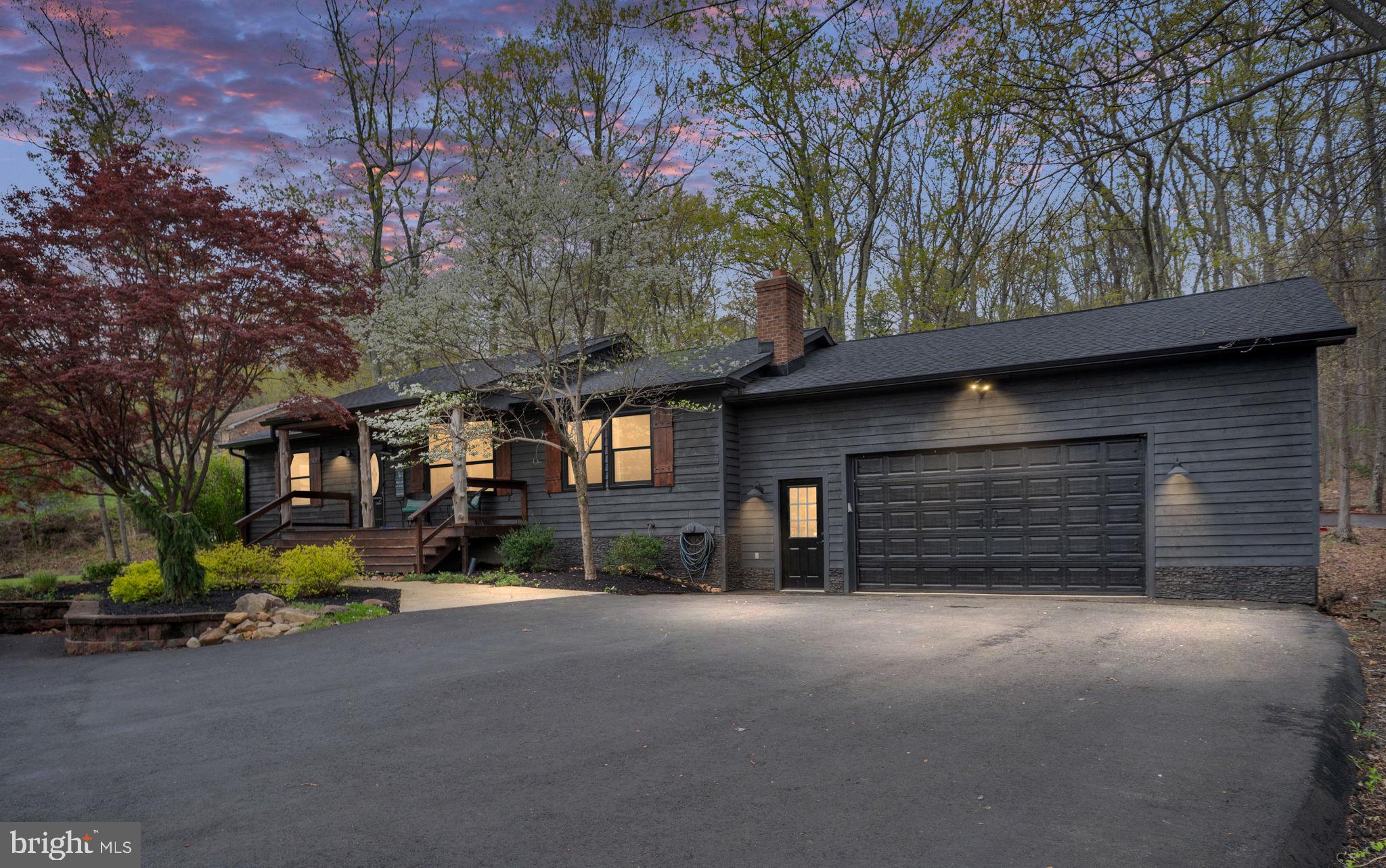 4098 Mountain Road Haymarket, VA 20169 - Photo 2 of 49 a view of a house with a yard and garage