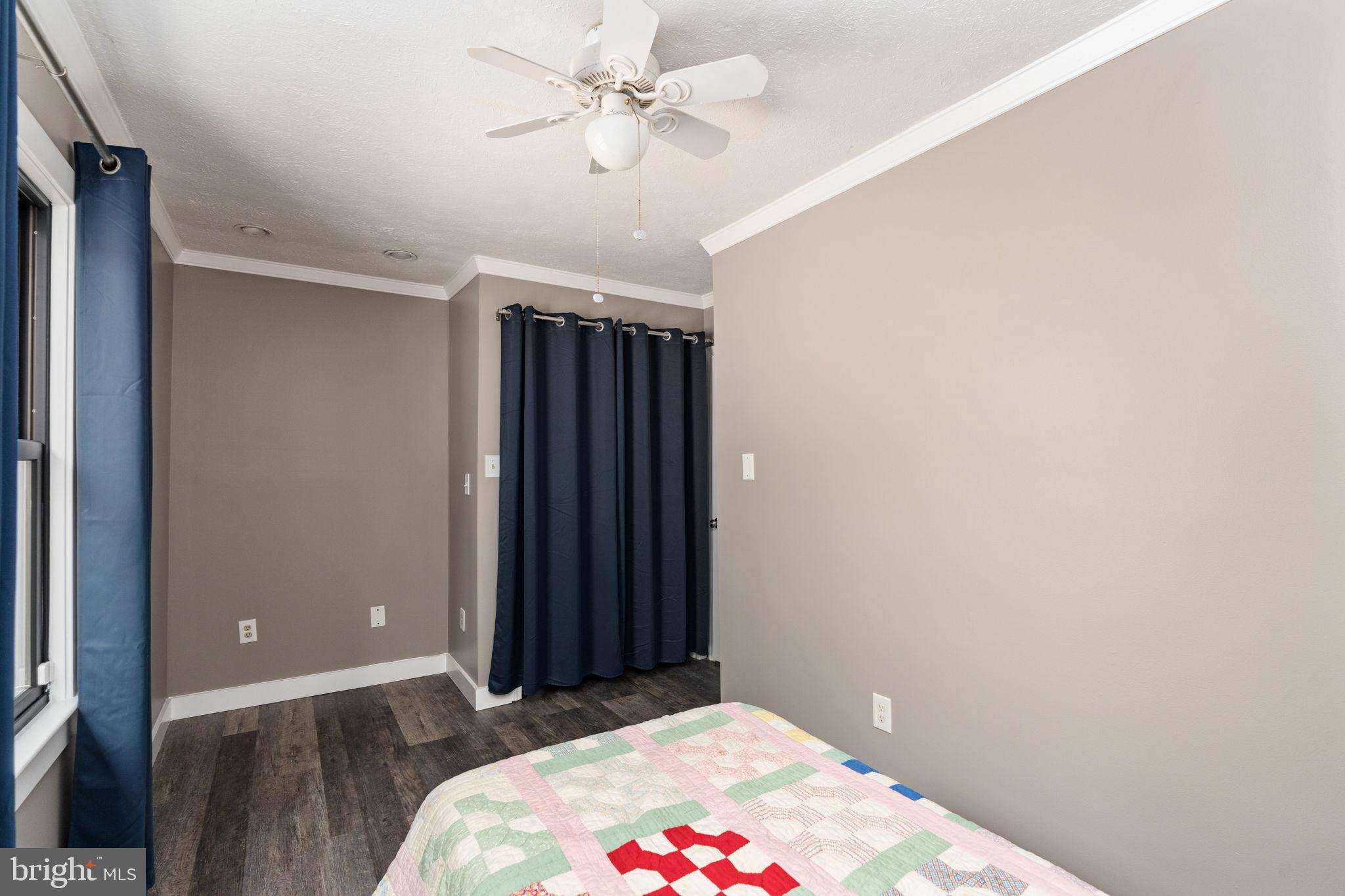 4098 Mountain Road Haymarket, VA 20169 - Photo 25 of 49 a bedroom with a bed and a chandelier fan