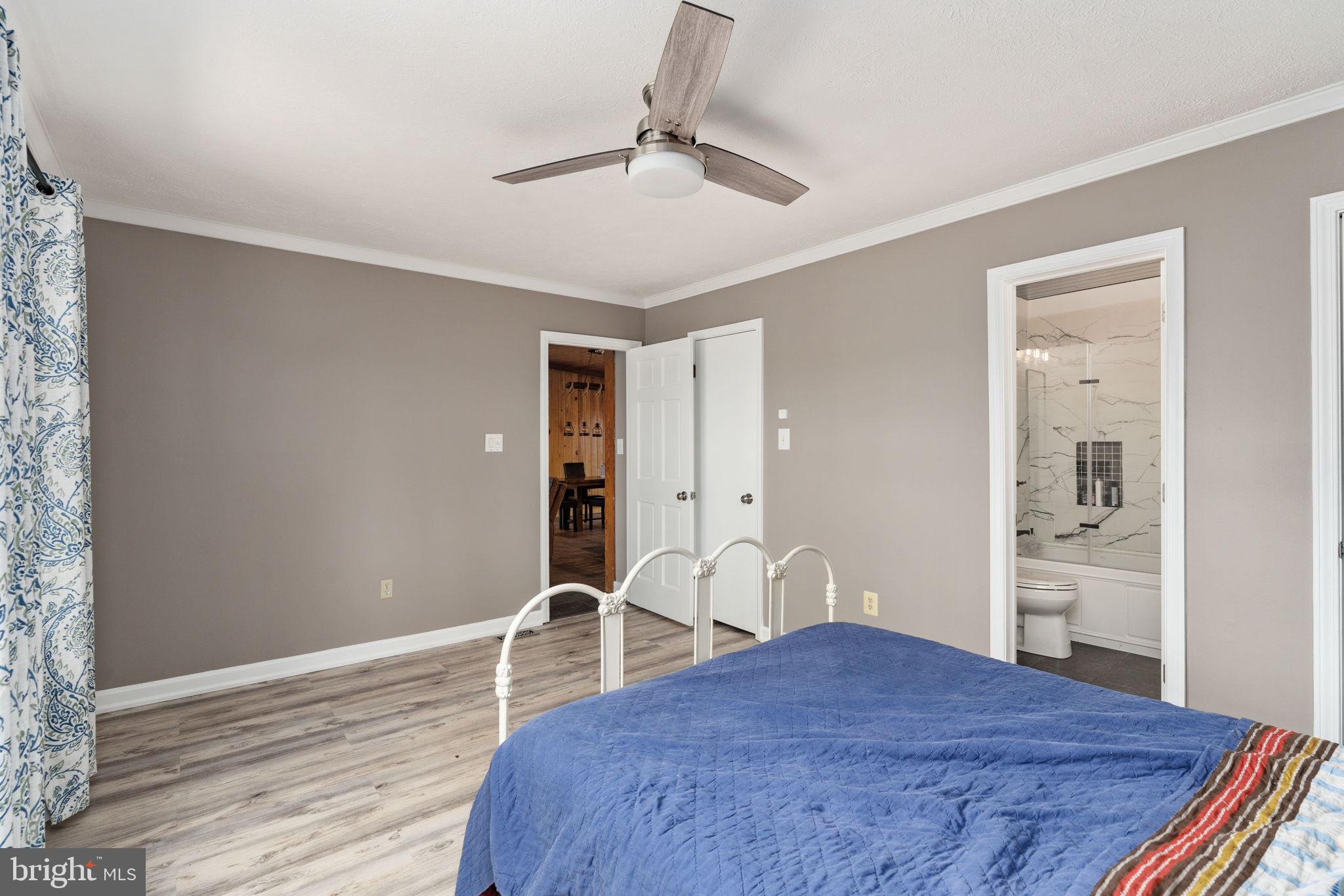 4098 Mountain Road Haymarket, VA 20169 - Photo 30 of 49 a bedroom with a bed and dresser with wooden floor