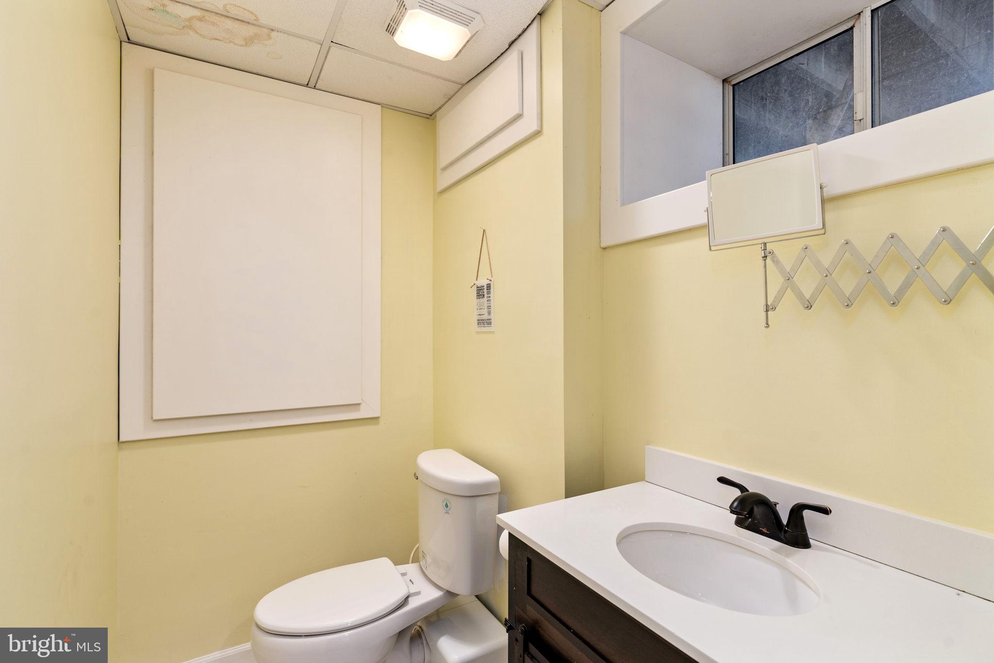4098 Mountain Road Haymarket, VA 20169 - Photo 35 of 49 a bathroom with a sink a toilet and shower curtain