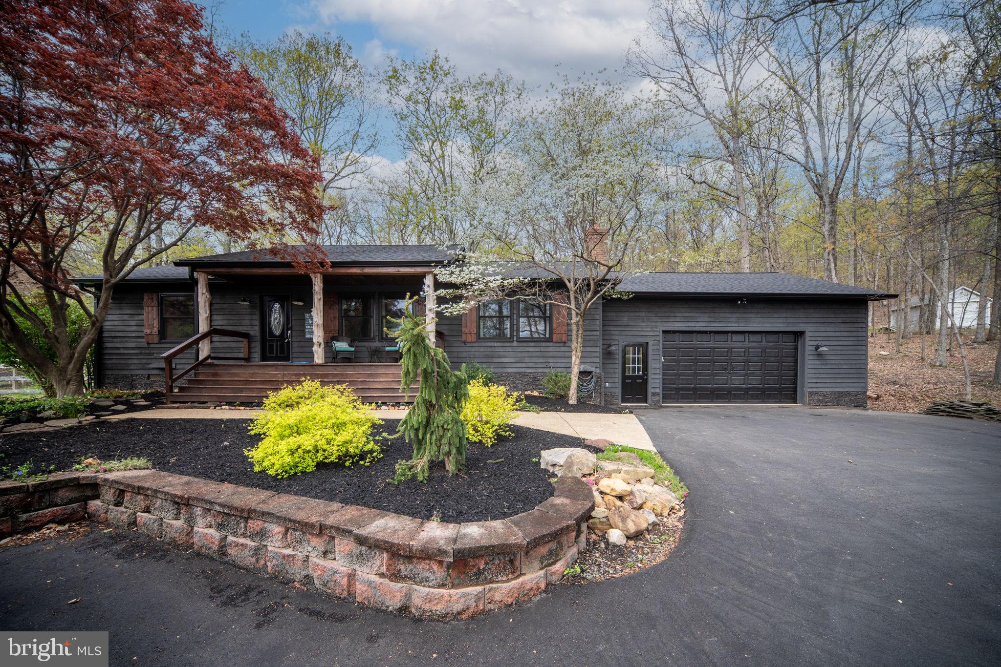 4098 Mountain Road Haymarket, VA 20169 - Photo 46 of 49 a front view of a house with a yard and outdoor seating