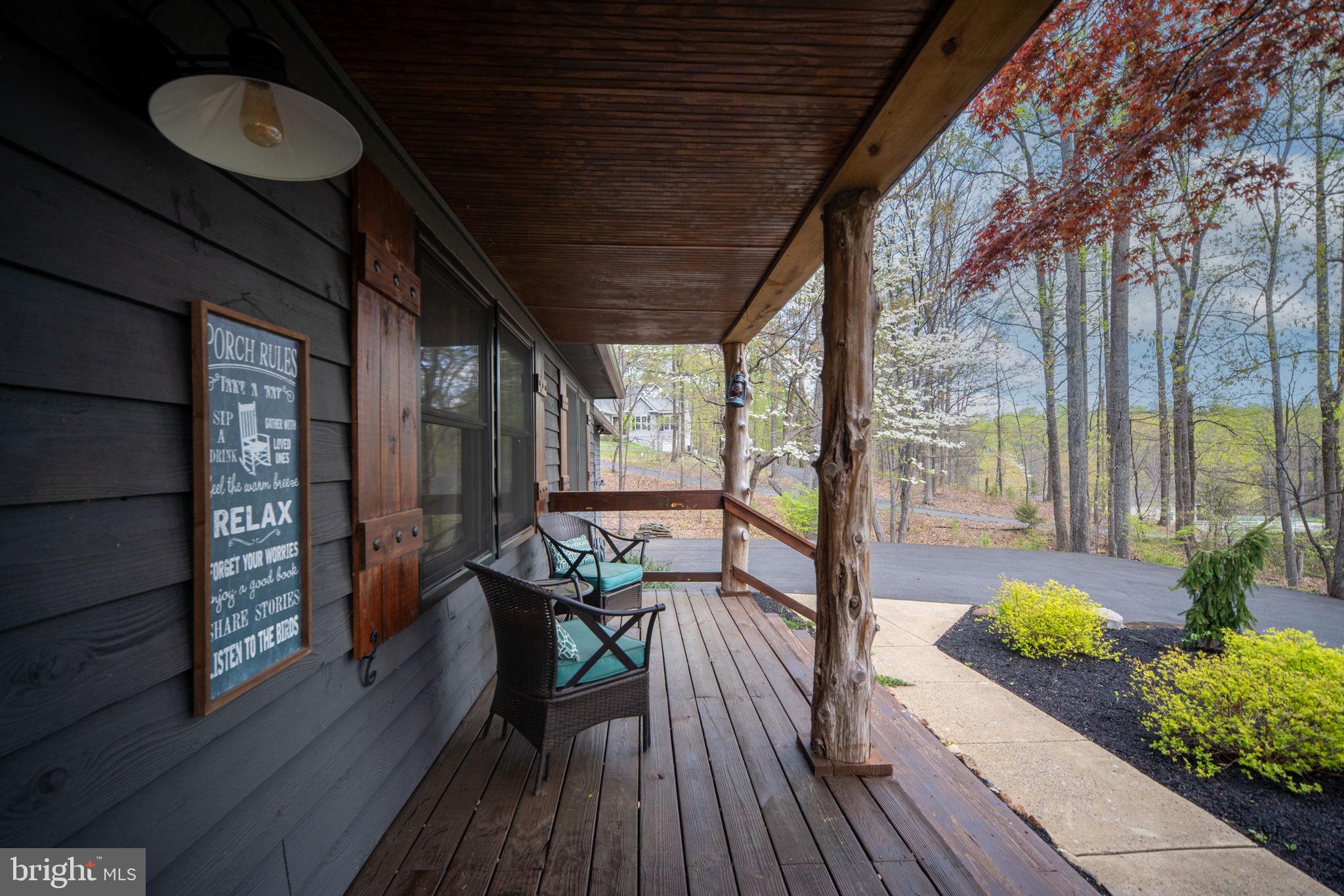 4098 Mountain Road Haymarket, VA 20169 - Photo 6 of 49 a view of a balcony with chairs and wooden floor