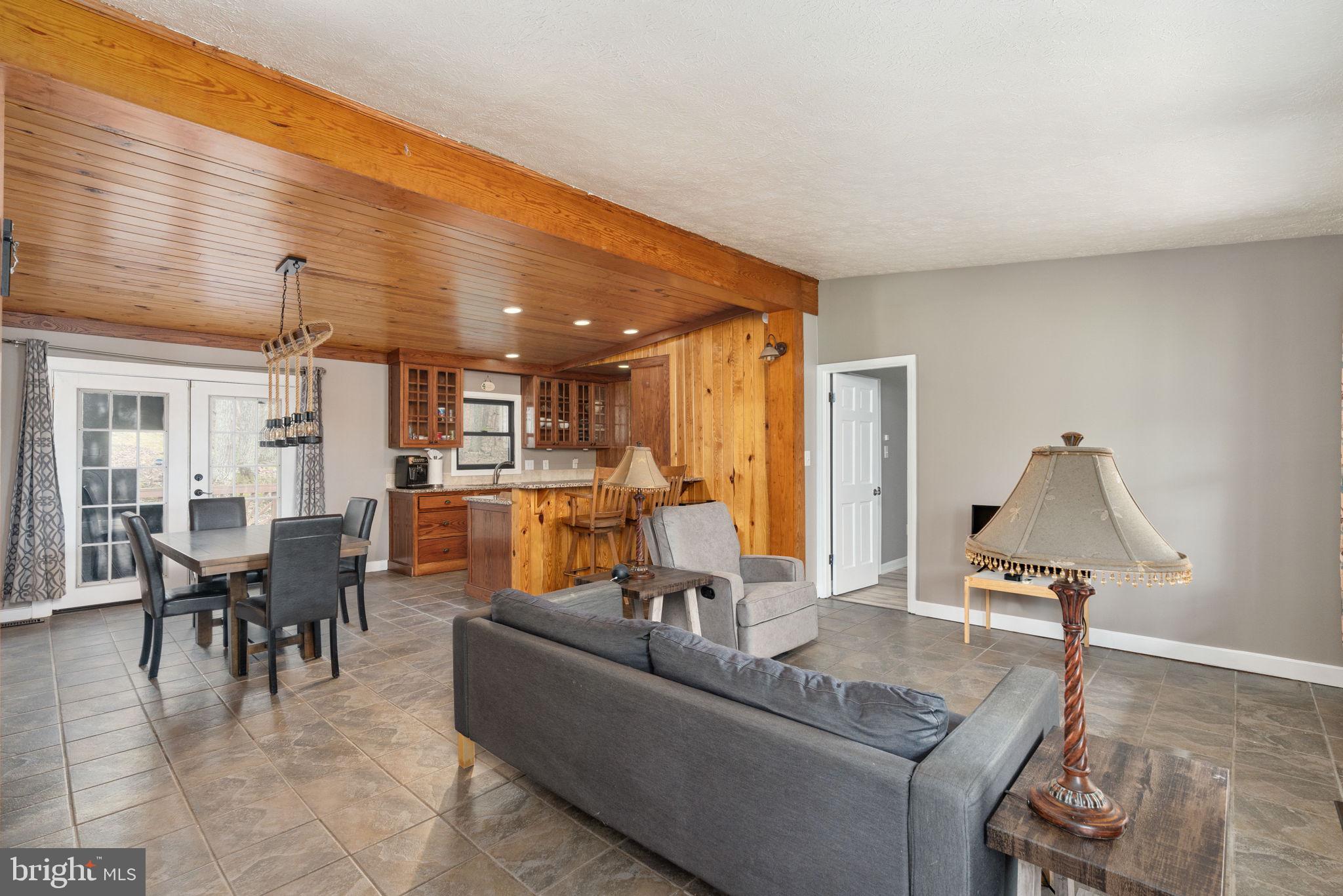 4098 Mountain Road Haymarket, VA 20169 - Photo 8 of 49 a living room with furniture and a dining table with kitchen view