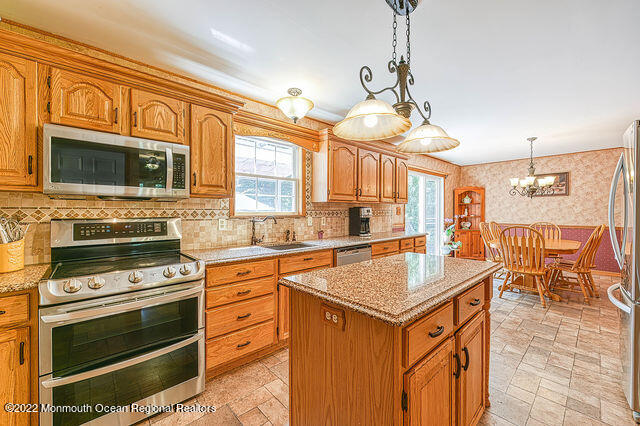 340 East Millstream Road Cream Ridge, NJ 08514 - Photo 20 of 40 a kitchen with granite countertop a stove cabinets and window