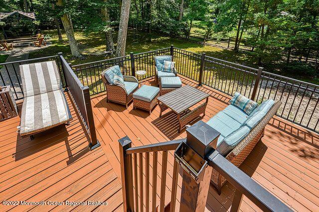 340 East Millstream Road Cream Ridge, NJ 08514 - Photo 32 of 40 a view of a balcony with wooden floor and outdoor seating