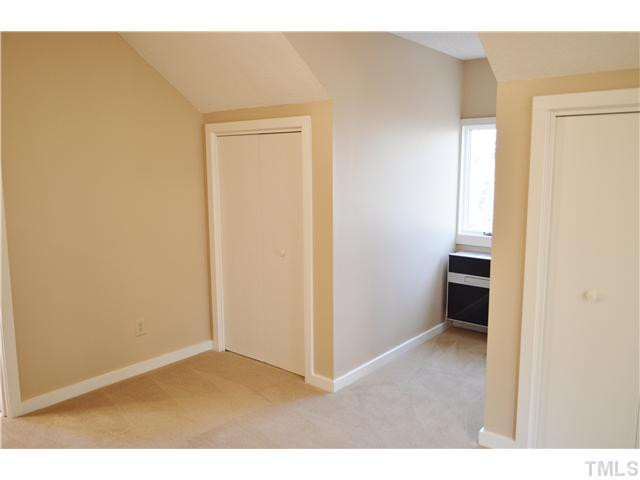 2405 Countrywood Road Raleigh, NC 27615 - Photo 21 of 25 This private upstairs bedroom suite has its own bath and a view of the back natural area. This area is heated by a Ymgi remote heat pump installed in 2011. This bedrooms adjoins the loft and has two closets. Bedroom