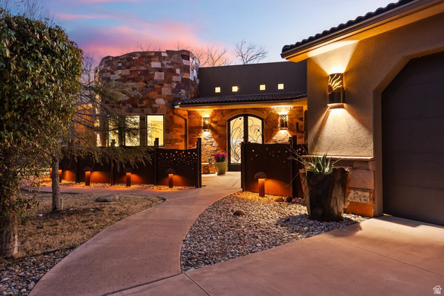98 Bridge Road Rockville, UT 84763 - Photo 3 of 75 Entrance to property featuring stone siding, a garage, stucco siding, and a tiled roof