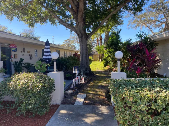 a view of a chairs and table in a backyard