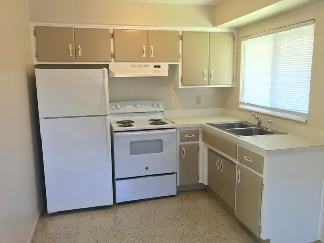 a kitchen with a stove sink and refrigerator