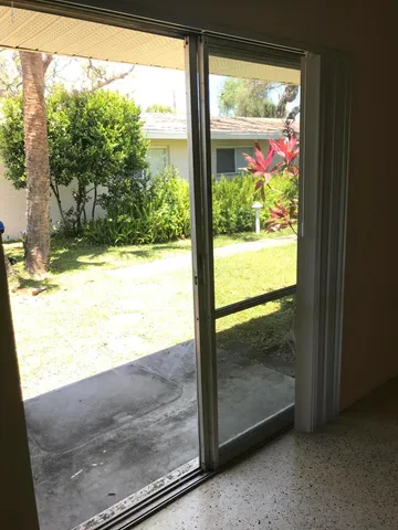 a view of a glass door with wooden floor