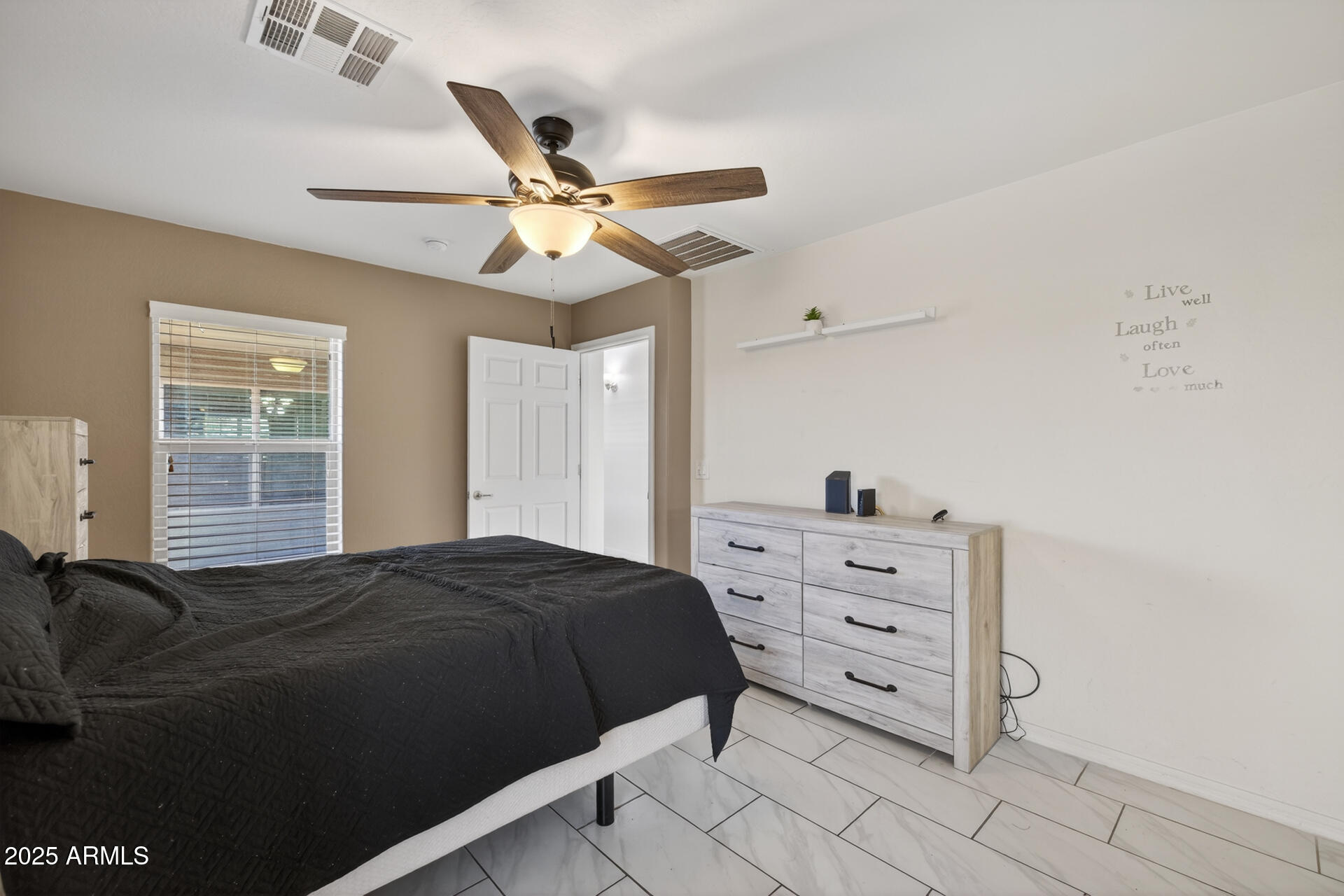 129 West Ian Drive Phoenix, AZ 85041 - Photo 10 of 21 a bedroom with a bed and a window