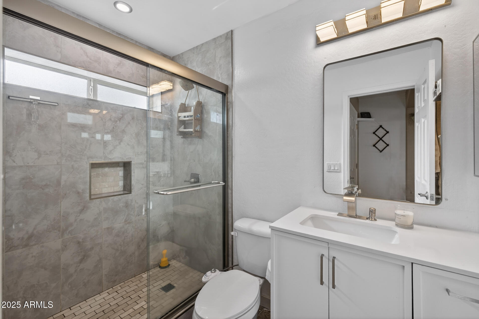 129 West Ian Drive Phoenix, AZ 85041 - Photo 11 of 21 a bathroom with a sink a toilet and shower