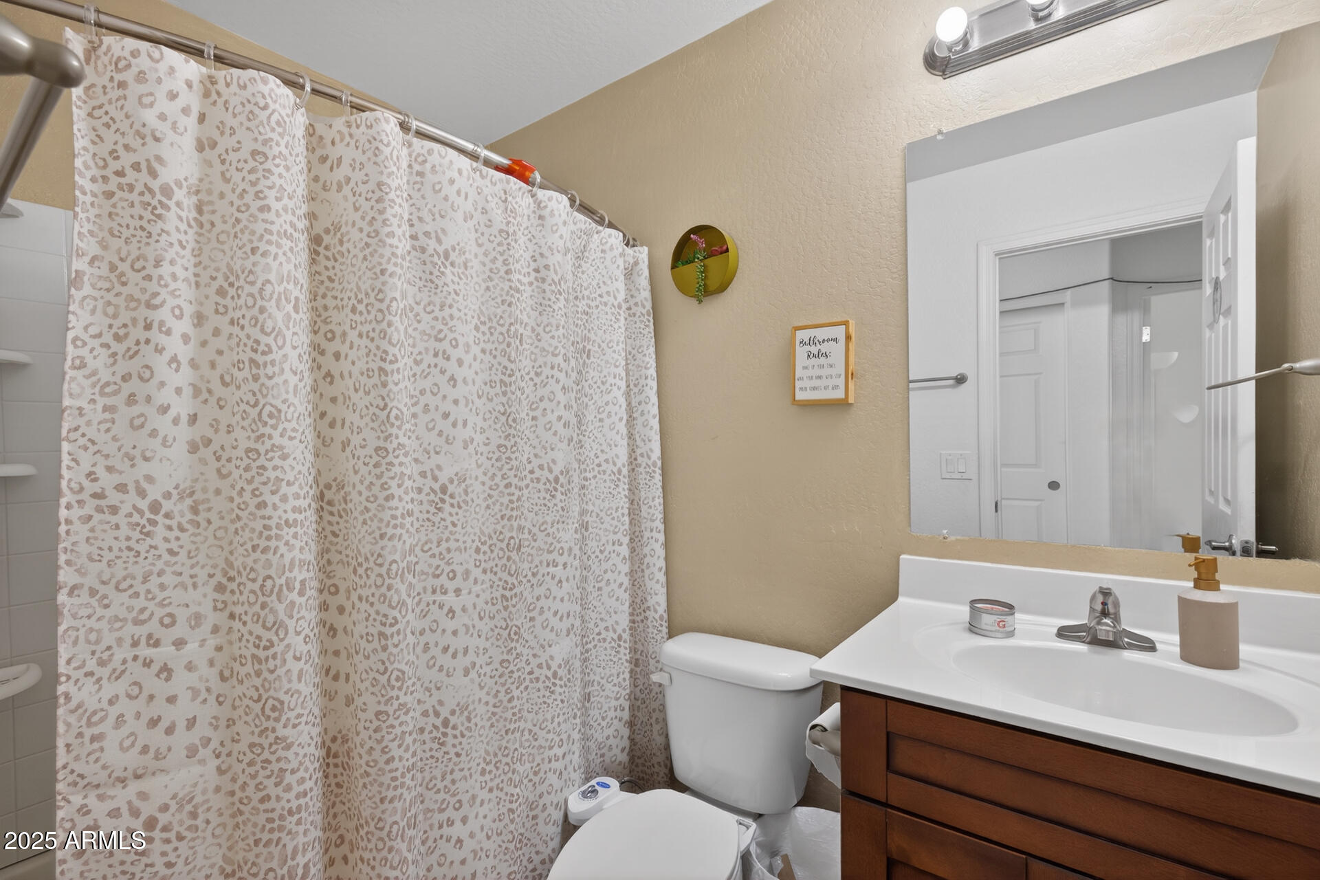 129 West Ian Drive Phoenix, AZ 85041 - Photo 13 of 21 a bathroom with a granite countertop sink and a mirror