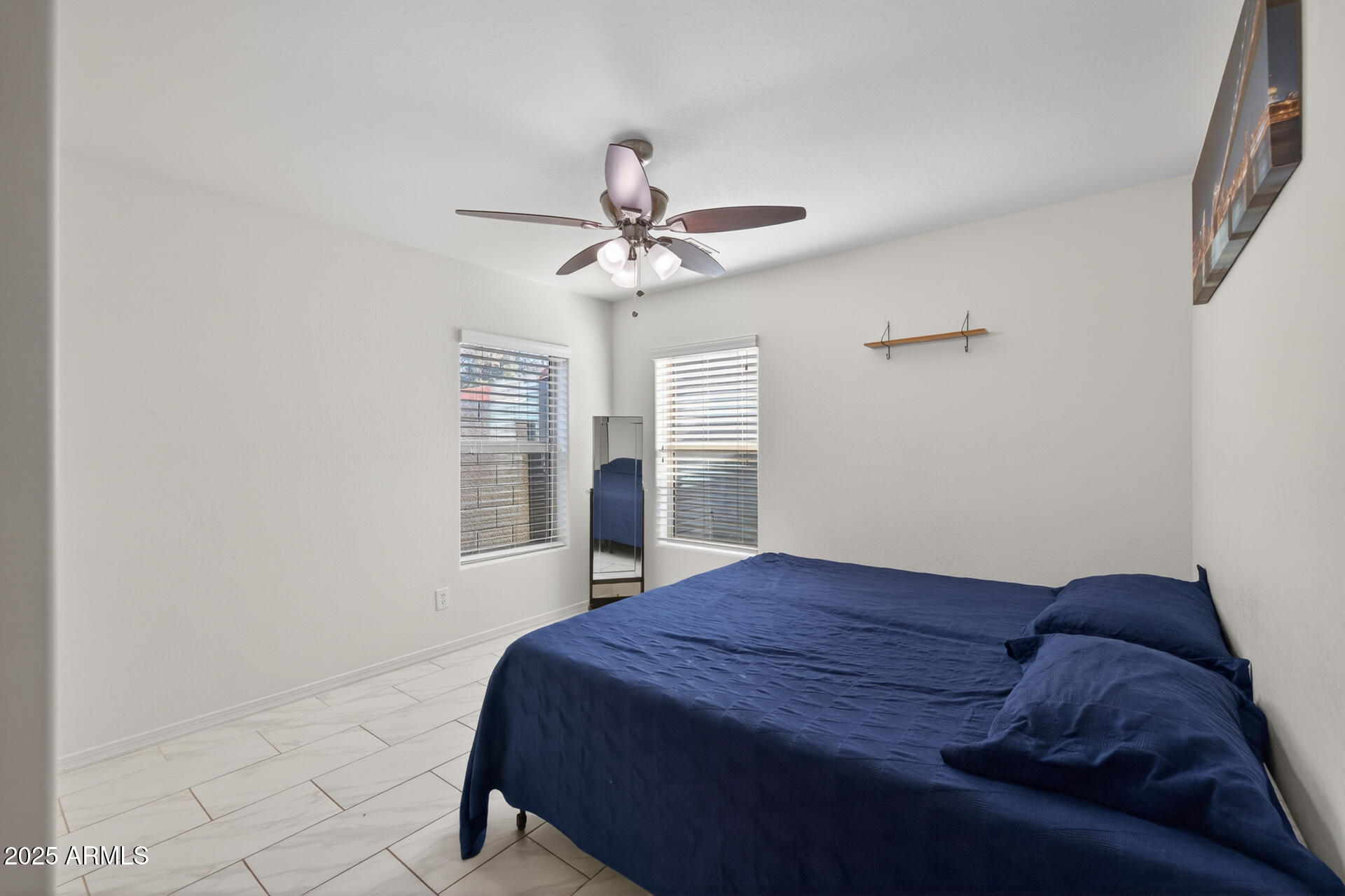 129 West Ian Drive Phoenix, AZ 85041 - Photo 14 of 21 a bedroom with a bed dresser and a window