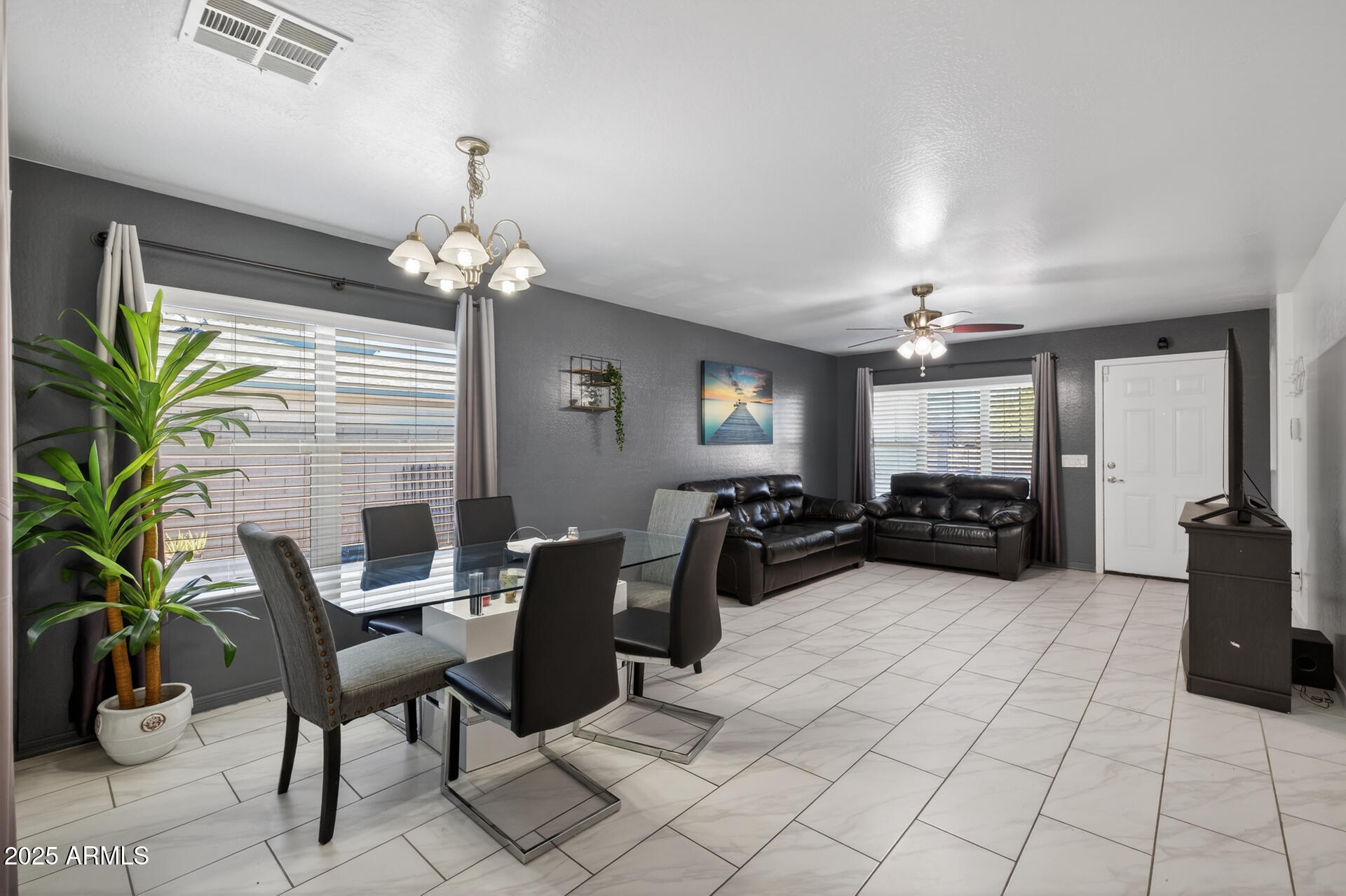129 West Ian Drive Phoenix, AZ 85041 - Photo 5 of 21 a view of a livingroom with furniture and a potted plant