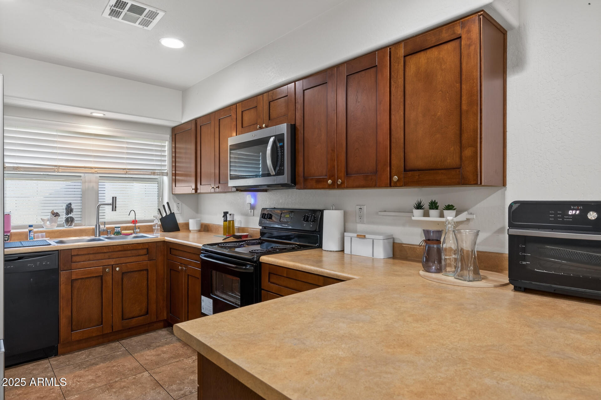 129 West Ian Drive Phoenix, AZ 85041 - Photo 6 of 21 a kitchen with a sink a stove cabinets and wooden floor