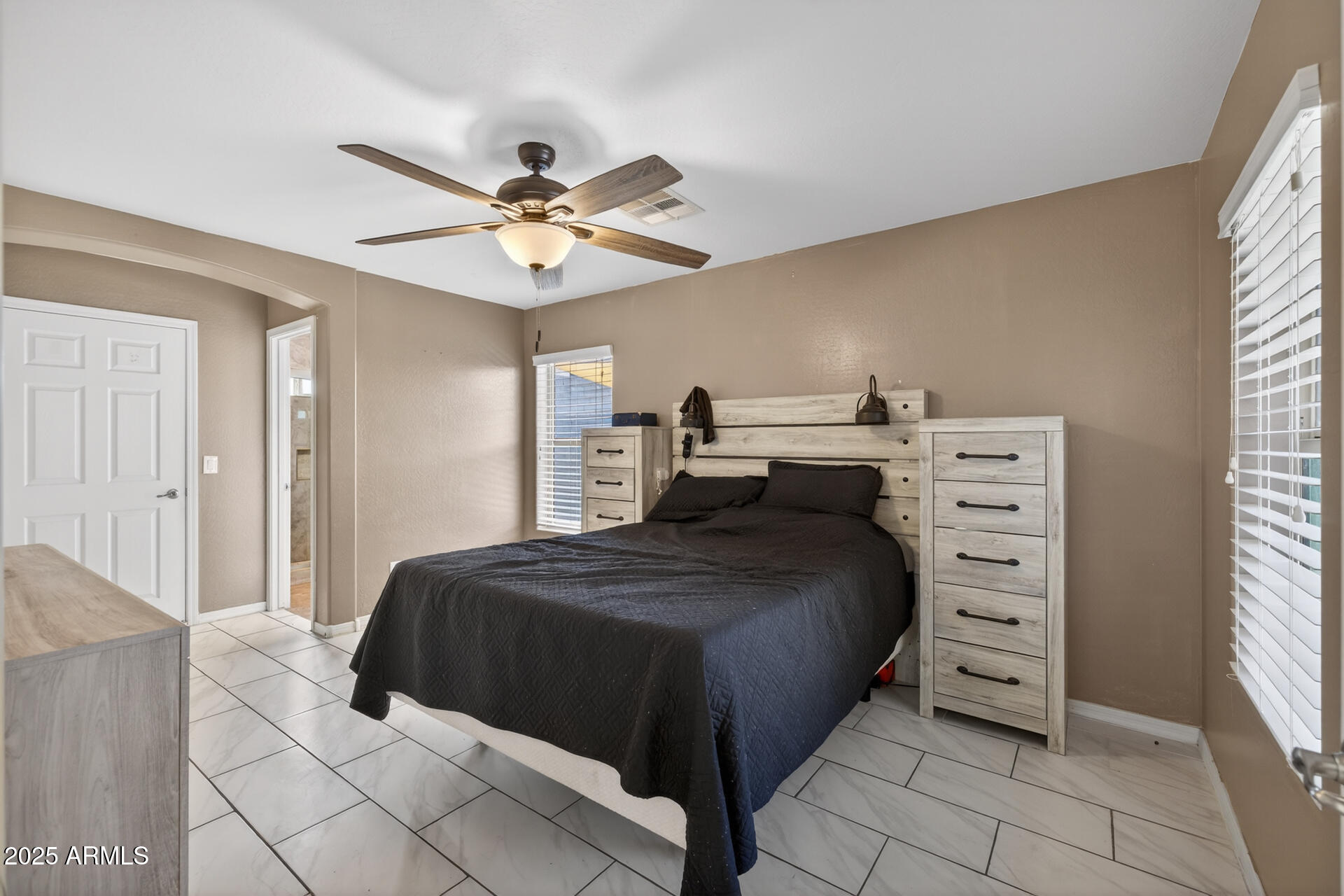 129 West Ian Drive Phoenix, AZ 85041 - Photo 9 of 21 a bedroom with a bed and a ceiling fan