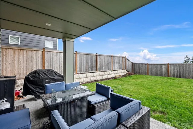a view of a backyard with wooden fence