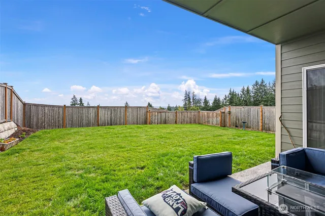 a view of a house with backyard and porch