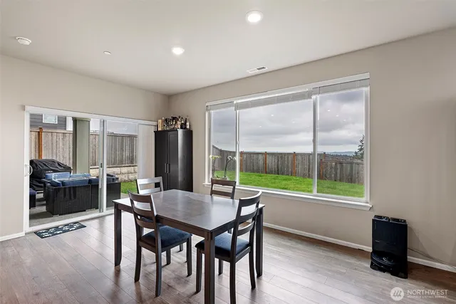 a dining room with furniture and wooden floor