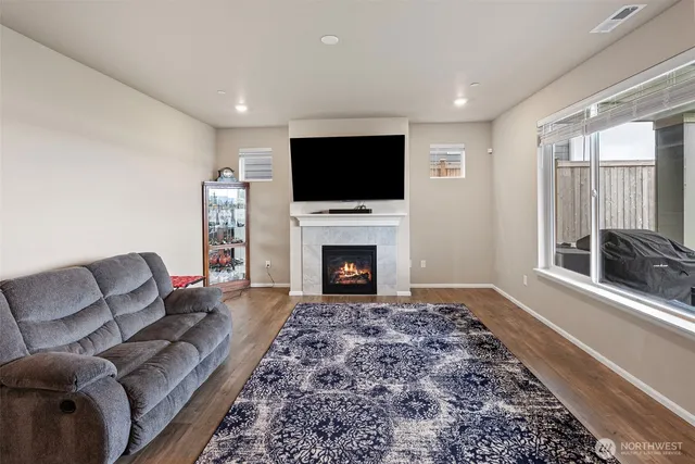 a bedroom with a bed and a flat tv screen on the dresser
