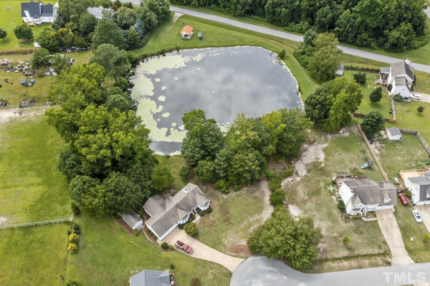 4912 Topstone Road Raleigh, NC 27603 - Photo 3 of 47 an aerial view of a house with a yard and lake view