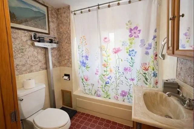 a view of a hallway with wooden floor and stairs