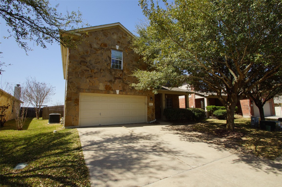 1651 Stone Rim Loop Buda, TX 78610 - Photo 1 of 1 a front view of a house with a yard