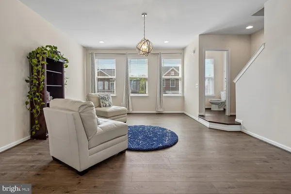 a living room with furniture and a chandelier