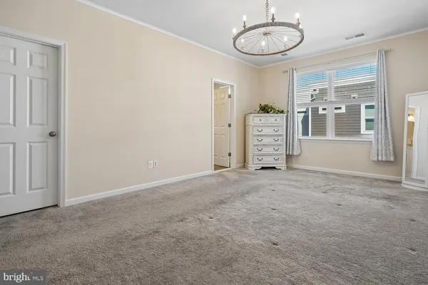an empty room with windows and ceiling fan