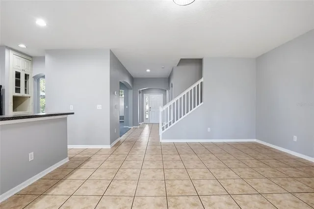 a view of a hallway with closet and mirror